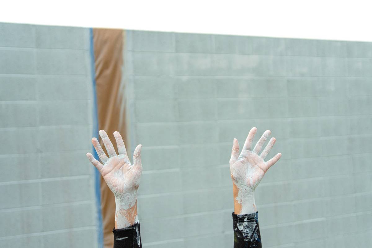 A climber wearing high-quality climbing gloves, gripping a rock surface with ease and confidence.