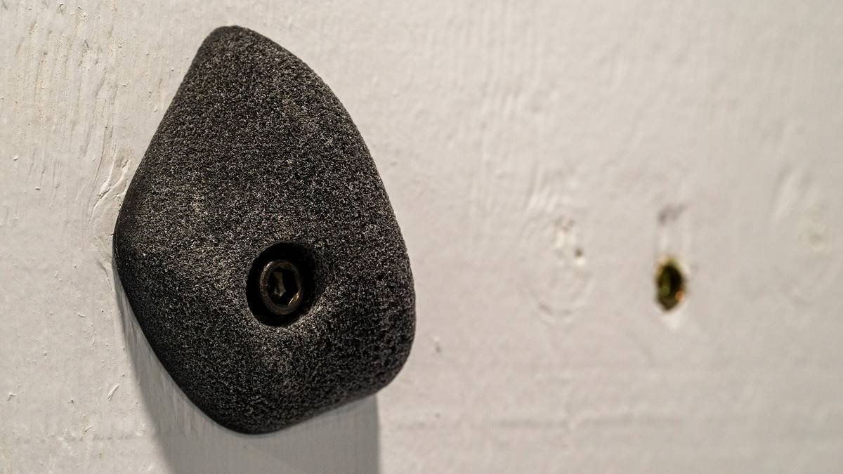 A close-up image of high-quality grip gloves designed for climbing and weightlifting.