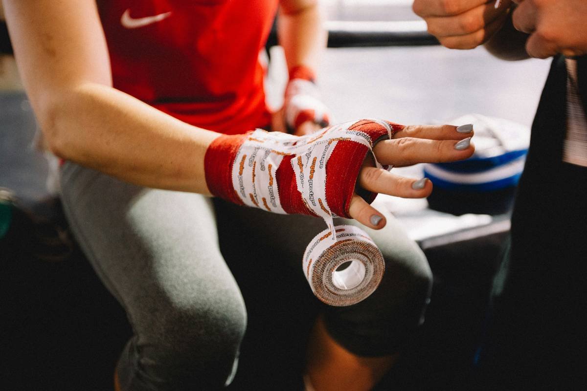A person wearing grip gloves while lifting weights