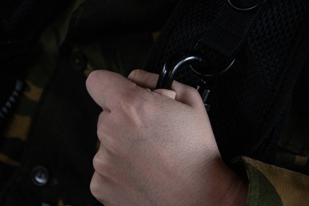 Climber adjusting hand posture with climbing gloves